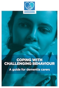 Front cover of Coping with Challenging Behaviour document featuring a picture of an anxious looking woman covering her mouth thoughtfully. Strapline reads A guide for dementia carers.